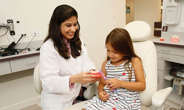 Dr. Bhave educating child patient