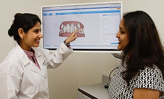 Dr. Bhave explaining to patient how Invisalign works.