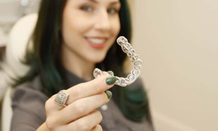 Patient holding Invisalign braces