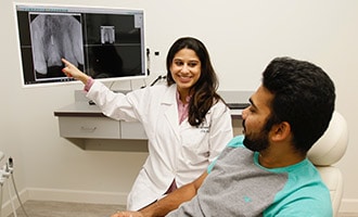 Doctor showing patient x-rays on a monitor