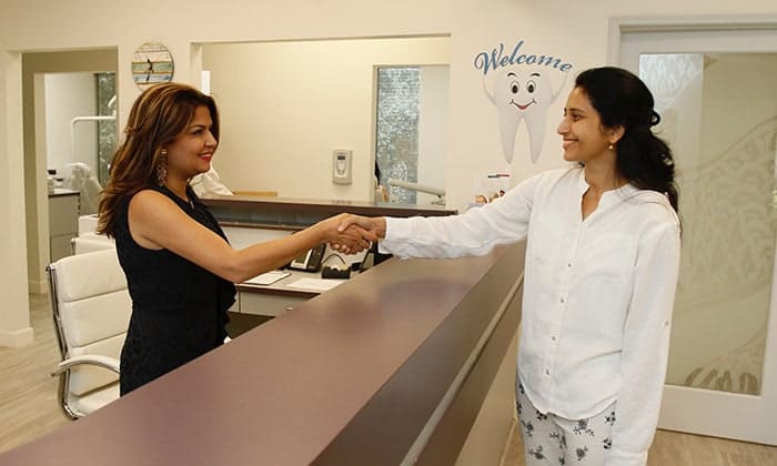 Receptionist greeting patient