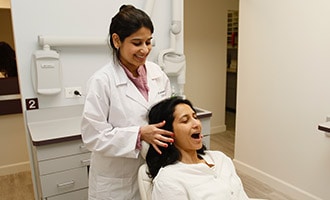 Dr. Bhave conducting exam with patient