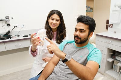 Dentist showing patient all-on-4 implants in San Jose