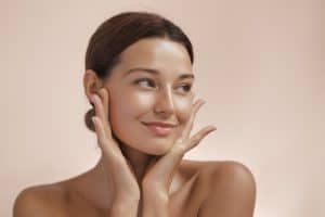Woman smiling with well defined chin from chin augmentation in Miami, FL