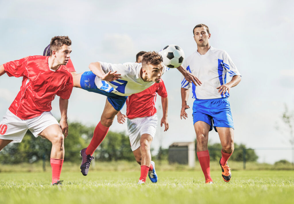 Soccer players on the field, after one man breaks his nose