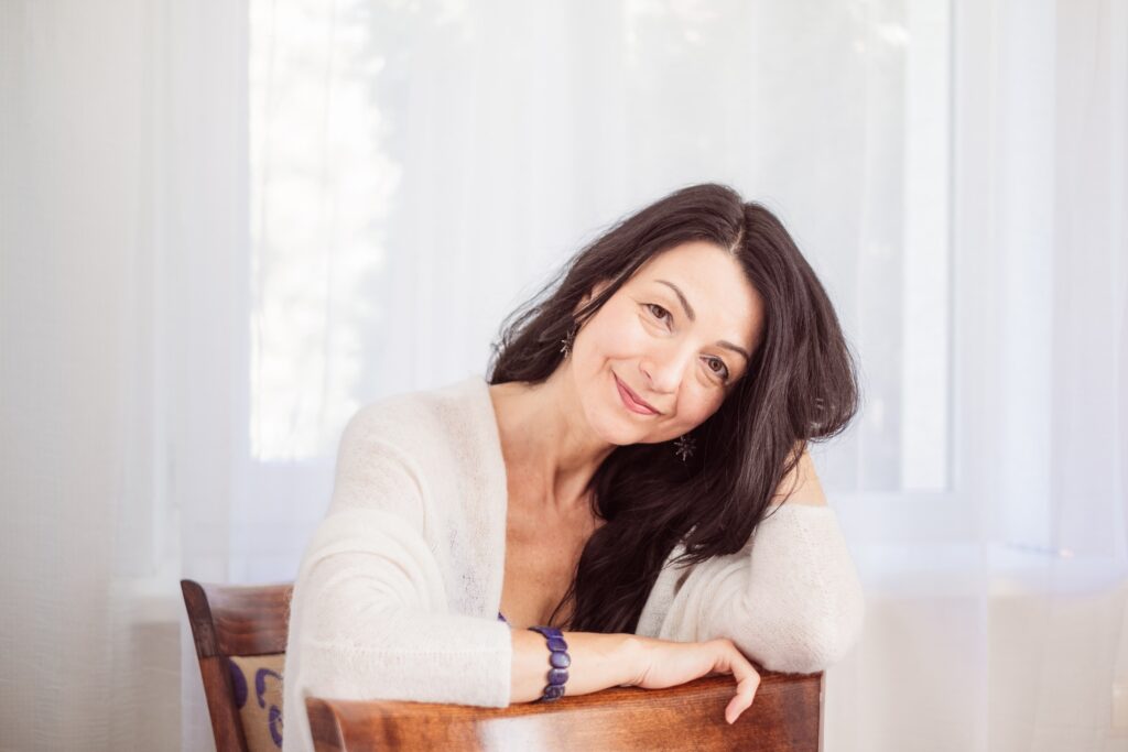 Attractive dark-haired woman smiles as she considers a menopause makeover