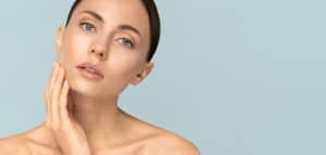 Beautiful woman tilts her head, pondering what type of facelift to get