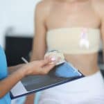 Woman discusses breast implant revision with her doctor