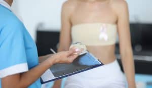 Woman discusses breast implant revision with her doctor