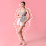 Pretty young woman holds a scale following her weight loss and lower body lift