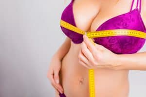 Close up of a woman with very large breasts, in need of breast reduction to improve comfort.