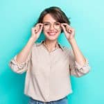 Woman holds glasses, but she is eager to have refractive surgery to ditch eyewear.