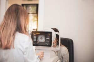 Eye doctor takes a look at a map of a patient's cornea.